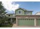 Lovely exterior featuring a green home with a three car attached garage at 919 Taylor Ln, Erie, CO 80516