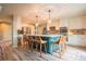Bright kitchen with white cabinetry, blue island, stainless steel appliances, and pendant lighting at 919 Taylor Ln, Erie, CO 80516
