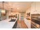 Spacious kitchen featuring a large island with seating, stainless appliances, and designer lighting at 919 Taylor Ln, Erie, CO 80516