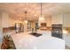 Spacious open kitchen with a large island, stainless steel appliances, and modern pendant lighting at 919 Taylor Ln, Erie, CO 80516