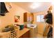 Functional laundry room featuring tile flooring, ample countertop space, and overhead storage at 919 Taylor Ln, Erie, CO 80516
