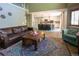Cozy living room offers a modern kitchen with a breakfast bar and an area rug for visual appeal at 919 Taylor Ln, Erie, CO 80516