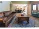 Bright living room features a modern kitchen with a breakfast bar and a large area rug for visual appeal at 919 Taylor Ln, Erie, CO 80516