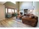 Sun-drenched living room boasts vaulted ceilings, a cozy fireplace, and a stylish rug complementing the wood floors at 919 Taylor Ln, Erie, CO 80516