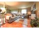 Cozy living room features two sofas, hardwood floors, and bright natural light from the window at 919 Taylor Ln, Erie, CO 80516