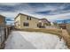 Backyard of home with snow on the ground and a fence at 5423 Ben Park Cir, Parker, CO 80134