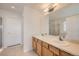 Bright full bathroom with double sink vanity and a large framed mirror at 5423 Ben Park Cir, Parker, CO 80134