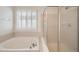 Bright full bathroom featuring a shower/tub and a shuttered window at 5423 Ben Park Cir, Parker, CO 80134