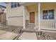 Inviting front porch with white railings, a wood door, and an attached two-car garage at 5423 Ben Park Cir, Parker, CO 80134