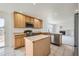 Well-equipped kitchen featuring stainless steel appliances, a central island, and bright lighting at 5423 Ben Park Cir, Parker, CO 80134