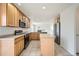 Functional kitchen layout with modern appliances, light wood cabinets, and an adjacent eating area at 5423 Ben Park Cir, Parker, CO 80134