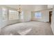 Bright and airy living room with large windows and neutral carpeting at 5423 Ben Park Cir, Parker, CO 80134