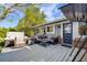 Relaxing back deck featuring a hot tub, outdoor seating, and a well maintained yard at 2764 S Reading Ct, Denver, CO 80231