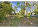 Backyard view featuring wooden deck perfect for outdoor gatherings nestled amongst the mature trees at 2764 S Reading Ct, Denver, CO 80231