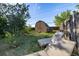 Private backyard oasis featuring a storage shed and comfortable lounge chairs nestled amidst lush greenery at 2764 S Reading Ct, Denver, CO 80231