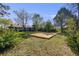 Expansive backyard featuring a new wooden deck with mature trees creating a serene outdoor space at 2764 S Reading Ct, Denver, CO 80231