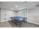 Basement game area featuring a STIGA ping pong table with windows in the background at 2764 S Reading Ct, Denver, CO 80231