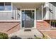 Inviting front entrance featuring a sleek black door, sidelights, and classic brick accents for a warm welcome at 2764 S Reading Ct, Denver, CO 80231