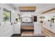 Modern kitchen featuring white cabinets, stainless steel range, and wood accents for a warm and inviting space at 2764 S Reading Ct, Denver, CO 80231