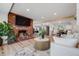 Open-concept living area with a brick fireplace, modern kitchen, and comfortable seating, perfect for entertaining at 2764 S Reading Ct, Denver, CO 80231