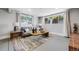 Cozy living room with two windows, a large area rug, and comfortable seating at 2764 S Reading Ct, Denver, CO 80231