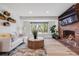 Inviting living room with a brick fireplace, large window, and comfortable sofa for relaxation at 2764 S Reading Ct, Denver, CO 80231