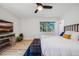 Spacious bedroom with a large window providing natural light, ceiling fan and wood-look floors at 2764 S Reading Ct, Denver, CO 80231