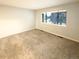 Bright bedroom with neutral carpeting and large window at 7995 E Mississippi Ave # F11, Denver, CO 80247