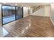 Living room with patio access, wood-look floors, and stairs to upper level at 7995 E Mississippi Ave # F11, Denver, CO 80247