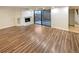 Living room with fireplace, sliding glass doors to patio and wood-look floors at 7995 E Mississippi Ave # F11, Denver, CO 80247