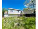 Backyard view featuring grass, a deck, and the rear exterior of the home at 19954 E Dartmouth Ave, Aurora, CO 80013