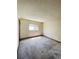 Empty bedroom with neutral walls, plush carpeting, and sunny window at 19954 E Dartmouth Ave, Aurora, CO 80013