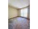 Empty bedroom with neutral walls, plush carpeting, and large sunny window at 19954 E Dartmouth Ave, Aurora, CO 80013