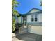 Two-story home with light-blue trim, brick, stairs, and a two-car garage at 19954 E Dartmouth Ave, Aurora, CO 80013