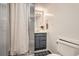 Tidy bathroom with shower, vanity, gray cabinet, and patterned tile at 3224 Troy St, Aurora, CO 80011