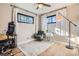 Cozy bedroom with natural light, neutral walls, hardwood floors, and a seating area at 3224 Troy St, Aurora, CO 80011