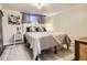 Bright bedroom boasts plush bedding, decor pillows, and soft lighting at 3224 Troy St, Aurora, CO 80011