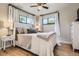 Charming bedroom features hardwood floors, a ceiling fan, and is illuminated by natural light at 3224 Troy St, Aurora, CO 80011