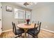 Cozy dining room with a round table, comfortable chairs, hardwood flooring, and natural light at 3224 Troy St, Aurora, CO 80011