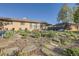 Well-maintained front yard with mature trees and flowering plants creates a peaceful and inviting setting at 3224 Troy St, Aurora, CO 80011