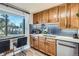 Modern kitchen features a large window with seating, wooden cabinets, and updated appliances at 3224 Troy St, Aurora, CO 80011