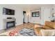Comfortable living room with a decorative fireplace, hardwood flooring and stylish furniture at 3224 Troy St, Aurora, CO 80011