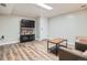 Finished basement living room with vinyl floors and a wall mounted television at 3224 Troy St, Aurora, CO 80011