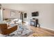 Bright living room with hardwood floors, modern fireplace, stylish decor, and a comfortable seating arrangement at 3224 Troy St, Aurora, CO 80011
