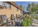 Charming patio with brick pavers, mature landscaping and comfortable seating; perfect for outdoor relaxation at 3224 Troy St, Aurora, CO 80011