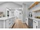 Modern kitchen with white cabinets, quartz countertops, and a farmhouse sink at 30 S Yates St, Denver, CO 80219