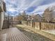 Backyard with deck, fence, and grassy area at 9125 Bell Flower Way, Highlands Ranch, CO 80126