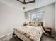 Bright bedroom with ceiling fan, plush bedding, and window blinds at 9125 Bell Flower Way, Highlands Ranch, CO 80126