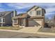 Two-story brick home with attached garage, well-maintained at 9125 Bell Flower Way, Highlands Ranch, CO 80126