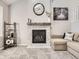 Modern fireplace with white stone surround and wooden mantel at 9125 Bell Flower Way, Highlands Ranch, CO 80126